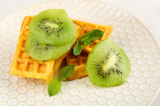 canva homemade waffles with kiwi and mint on a plate MAD MldEWIw