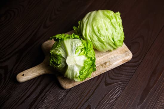 canva iceberg lettuce on cutting board on wooden table MAEP2FbDUe4