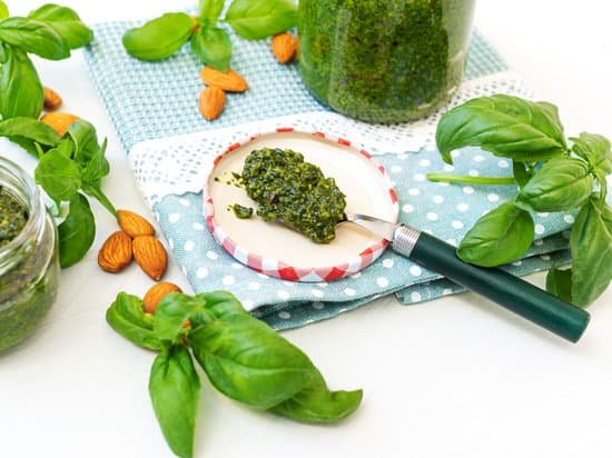 canva jar of home made basil pesto and ingredients. MAEmOyaZhnQ