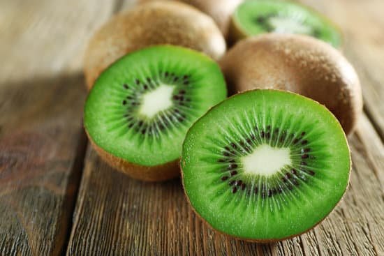 canva juicy kiwi fruit on wooden surface MAD MUvIEKg