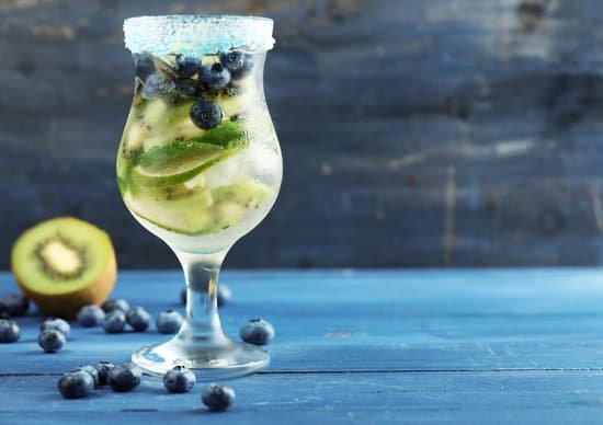 canva kiwi and blueberry cocktail in glass on colored wooden background MAD MjGRWSw