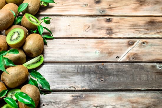 canva kiwis and leaves on a wooden table