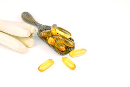 canva lemongrass capsule essential oil on wooden spoon with fresh lem MAESL4NPsTs