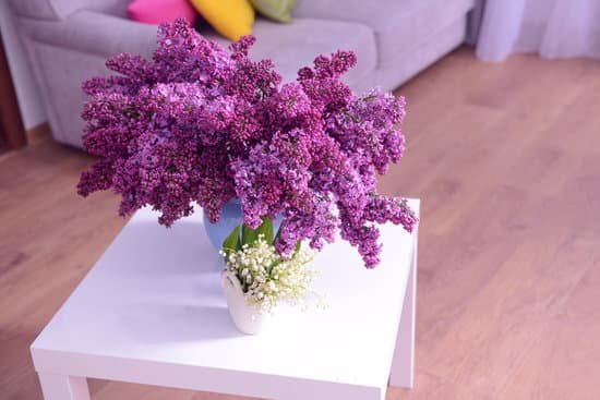 canva lilac and may lily flowers on white table MAD QtBDznk