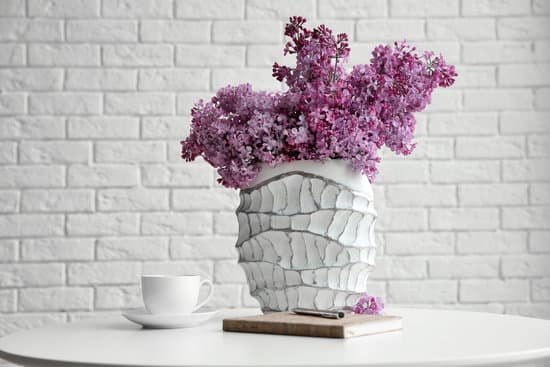 canva lilac flowers in a vase on white brick wall background MAD QsTl81U