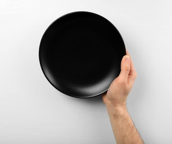 canva male hand holding black plate isolated on white MAEr68wXqYs