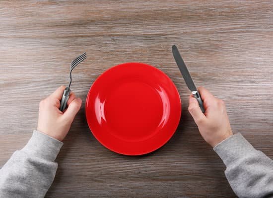canva man holding fork and knife with empty plate. hunger concept MAEsBatkLaQ