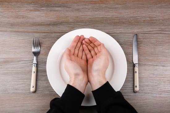 canva man holding hands over empty plate. hunger concept MAEsBav7y0E