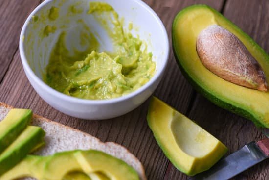 canva mashed and slices avocado on a table MAEAhpUgc7c