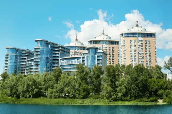 canva modern apartment buildings by the river bank MAD QwqENcs