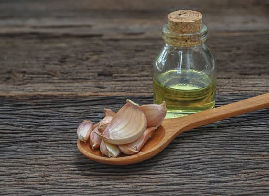 canva natural fresh garlic on wooden spoon MAERDWGE gM