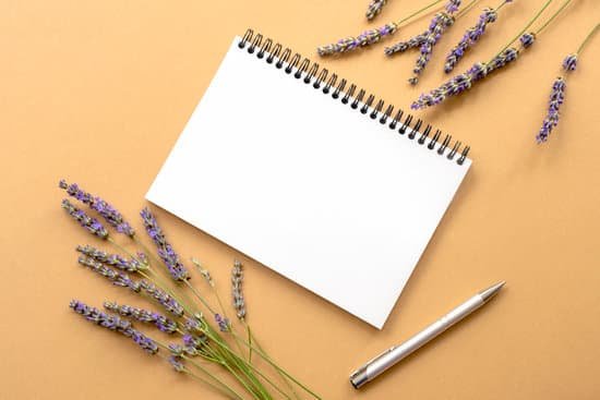 canva notebook and lavender flowers on a table MAECJhXKDWM