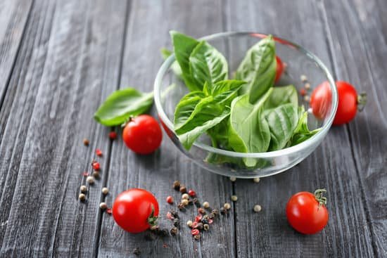 canva organic basil and cherry tomatoes on wooden background MAD9T1SwsY0