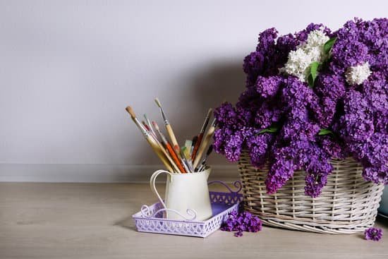canva paintbrushes and violet and white lilac flowers on basket MAD Maz1jyQ