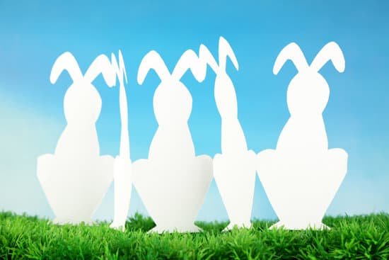 canva paper easter rabbits on green grass on sky background MAD 3WgvpT0