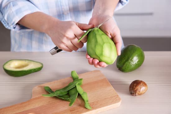 canva person cutting fresh avocado in kitchen MAD Qnv8EAk