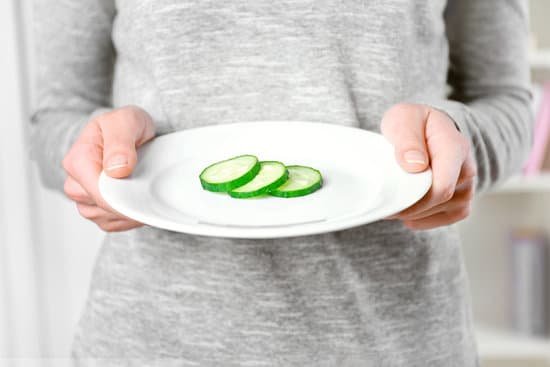 canva person hands holding a plate with slices of cucumber MAD Qnwo 4A