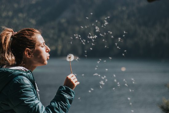 canva photo of woman blowing dandelion MADGv j8Xao