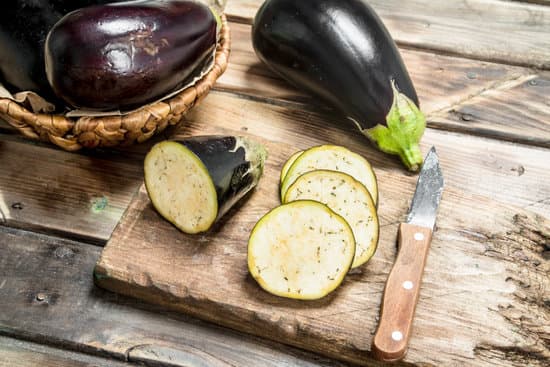 canva pieces of eggplant on a cutting board with a knife MAEPjAlfZw0