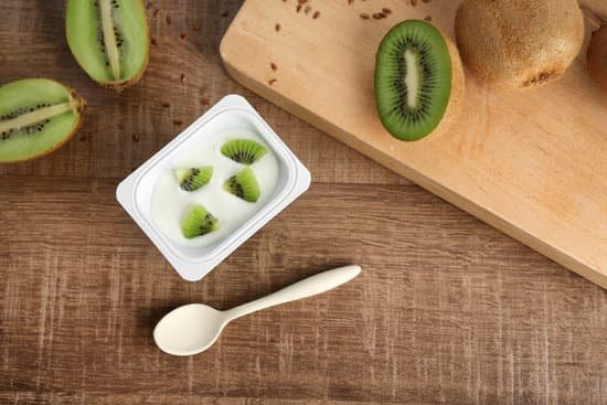 canva plastic cup of yummy kiwi yogurt on wooden table MAD70g80b4c