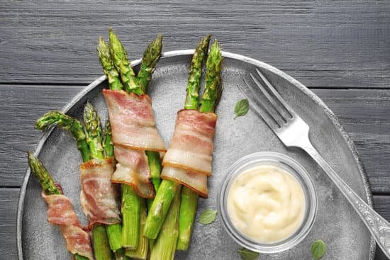 canva plate of asparagus wrapped with bacon with a dip MAD9UFJ0w 4