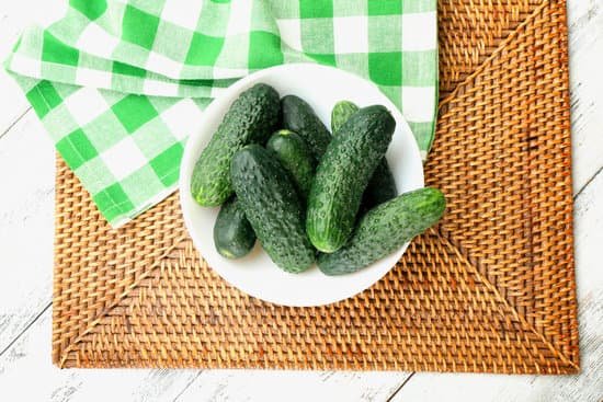 canva plate of fresh whole cucumbers on green checkered napkin MAD Mhy2vbg