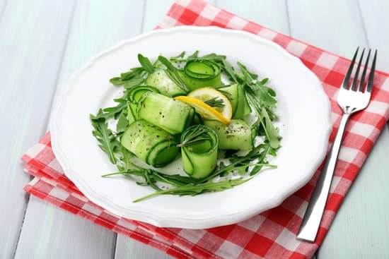 canva plate of refreshing cucumber and arugula salad on wooden table MAD MPjmla4