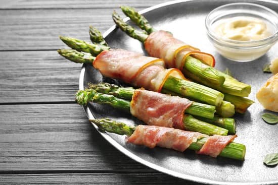 canva plate with bacon wrapped asparagus on light background MAD9UMCkhLw
