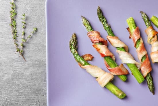 canva plate with bacon wrapped asparagus on table MAD9UGOj3Jg