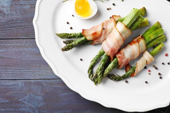 canva plate with bacon wrapped asparagus on table