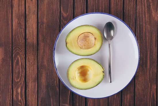 canva plate with fresh avocado on wooden background MAD Ql vfqw