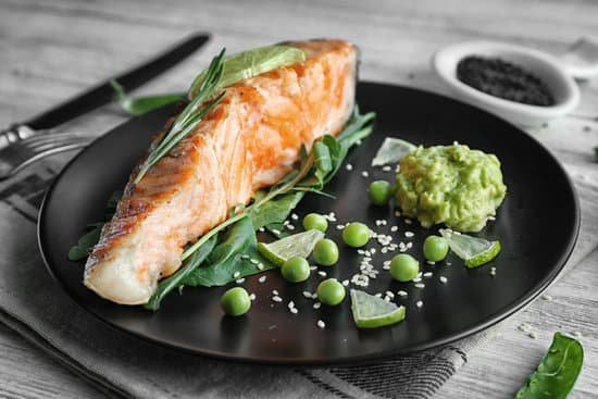 canva plate with slice of salmon herbs and avocado sauce MAD9bbIkBHo