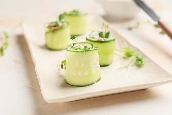 canva plate with tasty cucumber rolls on table MAD8S4reHbU
