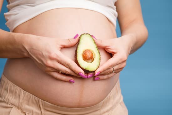 canva pregnant woman holding half of avocado MAEAv86AaiE