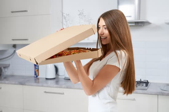 canva pretty woman opening box with hot pizza. MAEat iQ2RU