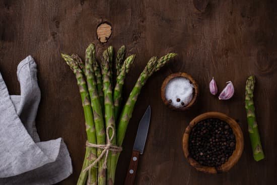 canva raw ripe green asparagus on a wooden background MAEAyDdcuiI