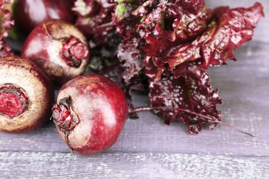 canva red beets with lettuce on wooden table close up MAD Ma10EnE