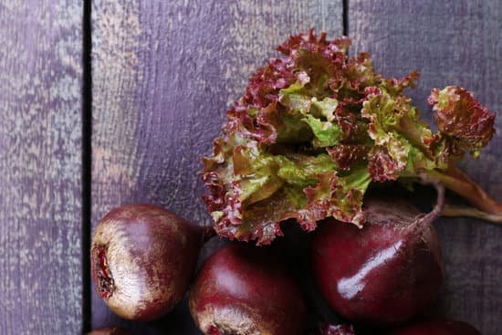 canva red beets with lettuce on wooden table close up MAD McaeBhc