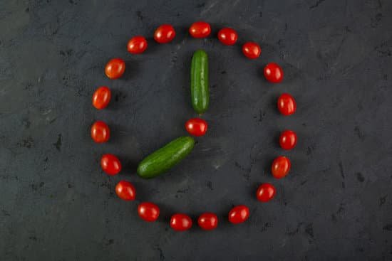 canva red cherry tomatoes and green cucumbers on dark background MAD70iJssBY