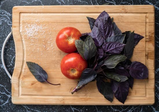 canva red tomatoes and purple basil leaves on wooden cutting board MAEB2OiTLaE
