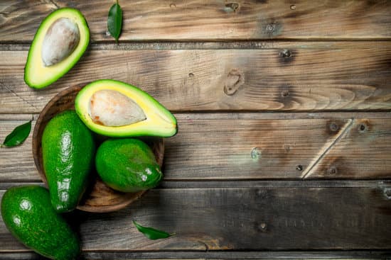 canva ripe avocados in a wooden bowl MAEPyXBd128