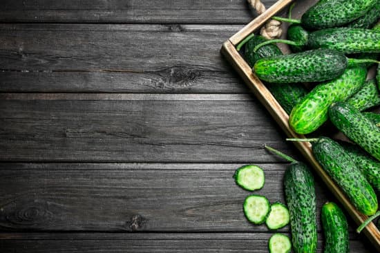 canva ripe cucumbers in a wooden tray copy space MAEPm2Ru rQ