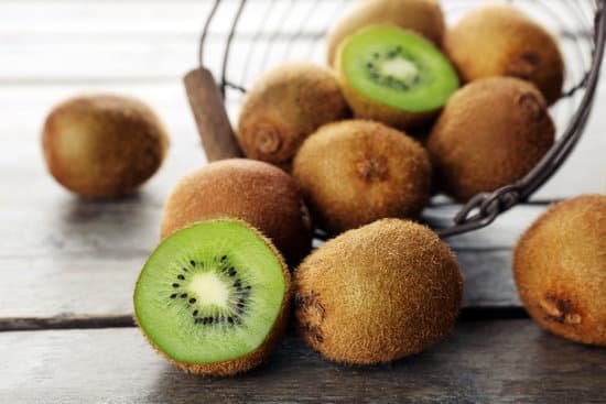 canva ripe kiwi in basket on wooden table MAD MXqIh E