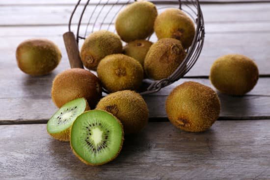 canva ripe kiwi in basket on wooden table close up MAD MUd7vUU