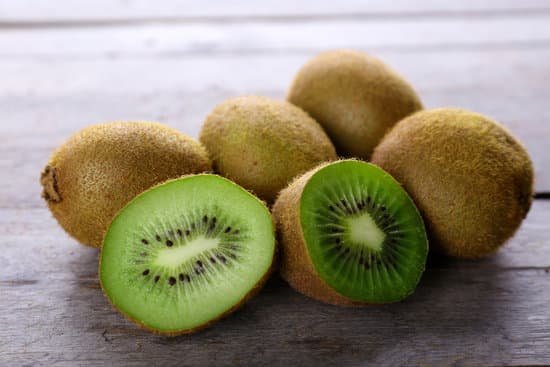 canva ripe kiwi on wooden table MAD MXQWsYs