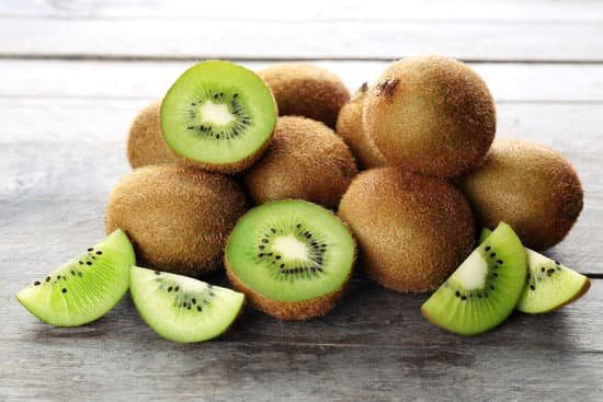 canva ripe kiwi on wooden table MAD MaVn9Vc