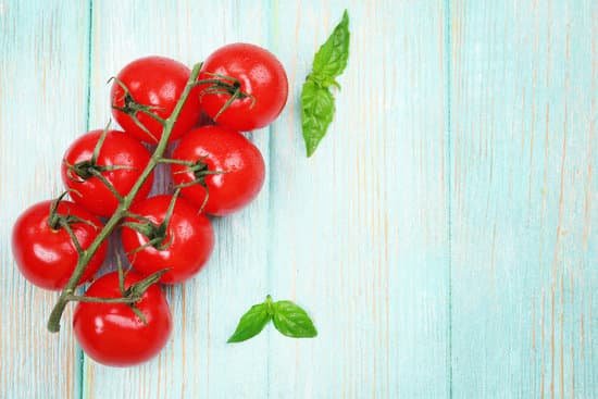 canva ripe tomatoes with basil on wooden background MAD MQk9S28