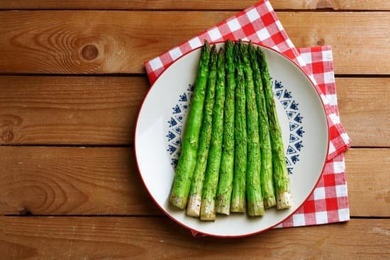 canva roasted asparagus on plate on table background MAD MQbDZ00