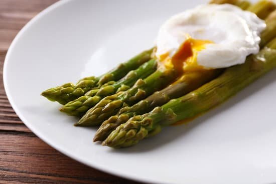 canva roasted asparagus with poached egg on plate on table MAD MbqgdSE