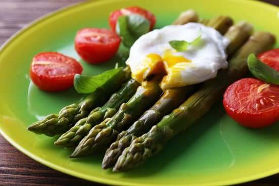 canva roasted asparagus with tomatoes and poached egg on plate MAD MTGWujE